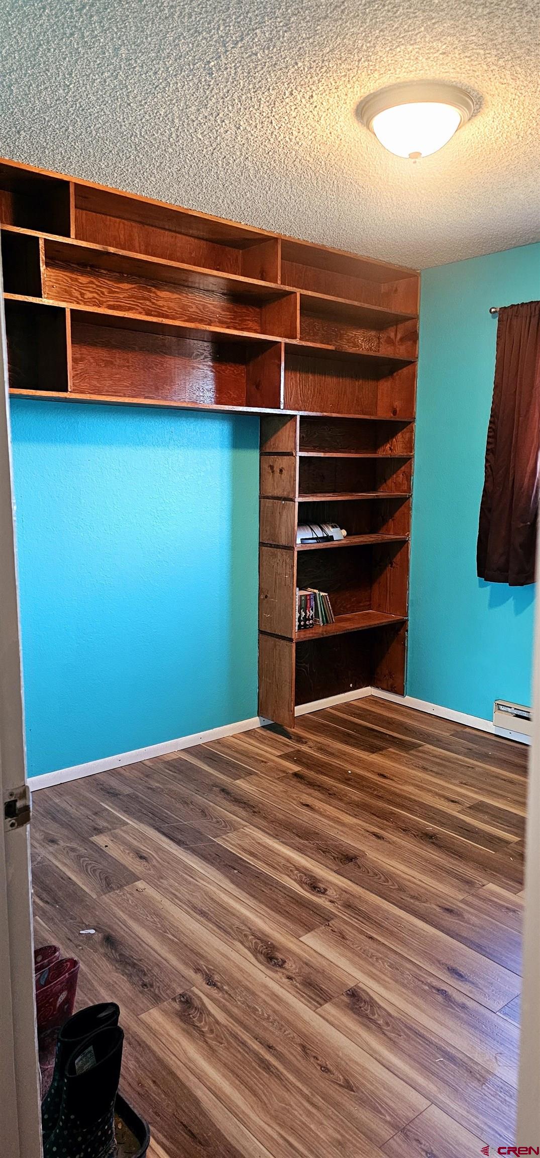 1726 Aldridge Road Cortez, CO 81321 - Photo 12 of 32 Spacious closet with a baseboard heating unit and wood finished floors