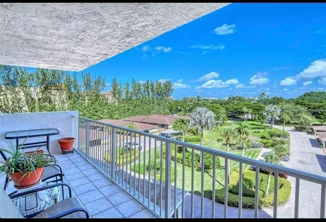 a view of a chairs and a table in the balcony