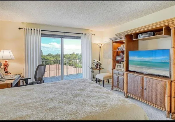 a bedroom with a large bed and a large window