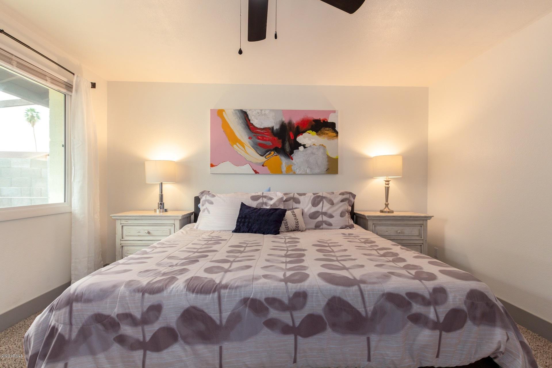 2439 East Riviera Drive Tempe, AZ 85282 - Photo 18 of 40 a bedroom with a bed and painting on the wall
