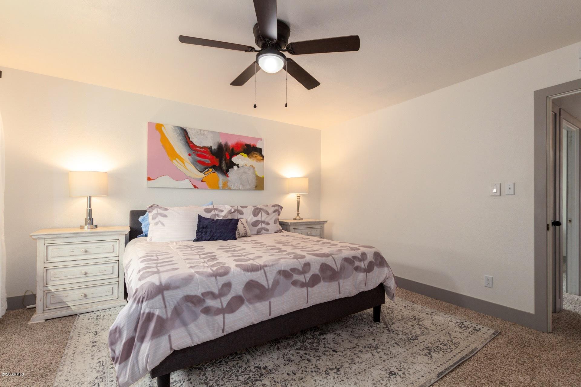 2439 East Riviera Drive Tempe, AZ 85282 - Photo 19 of 40 a bedroom with a bed and a painting on the wall