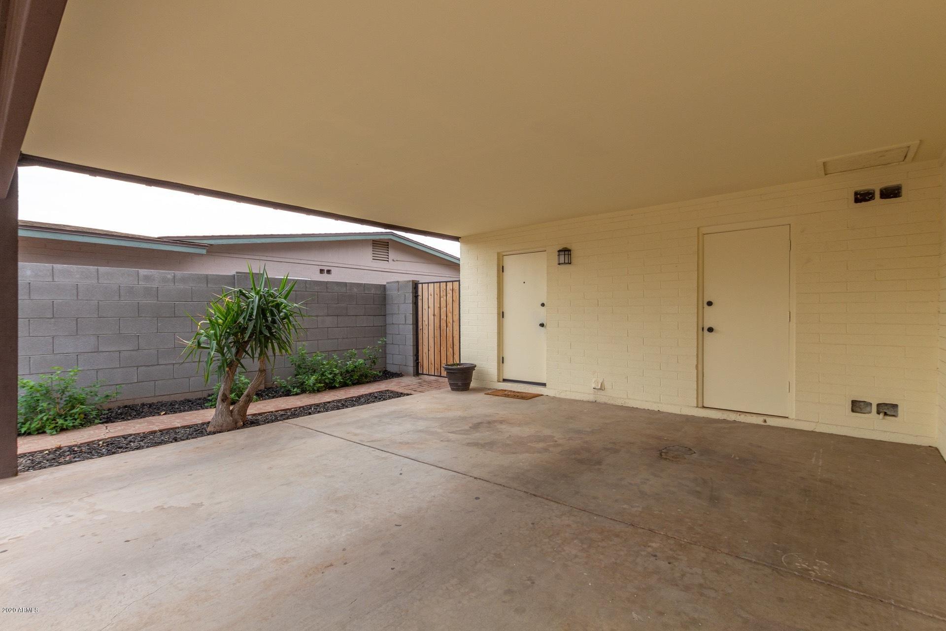2439 East Riviera Drive Tempe, AZ 85282 - Photo 4 of 40 a view of a house with a yard and potted plants