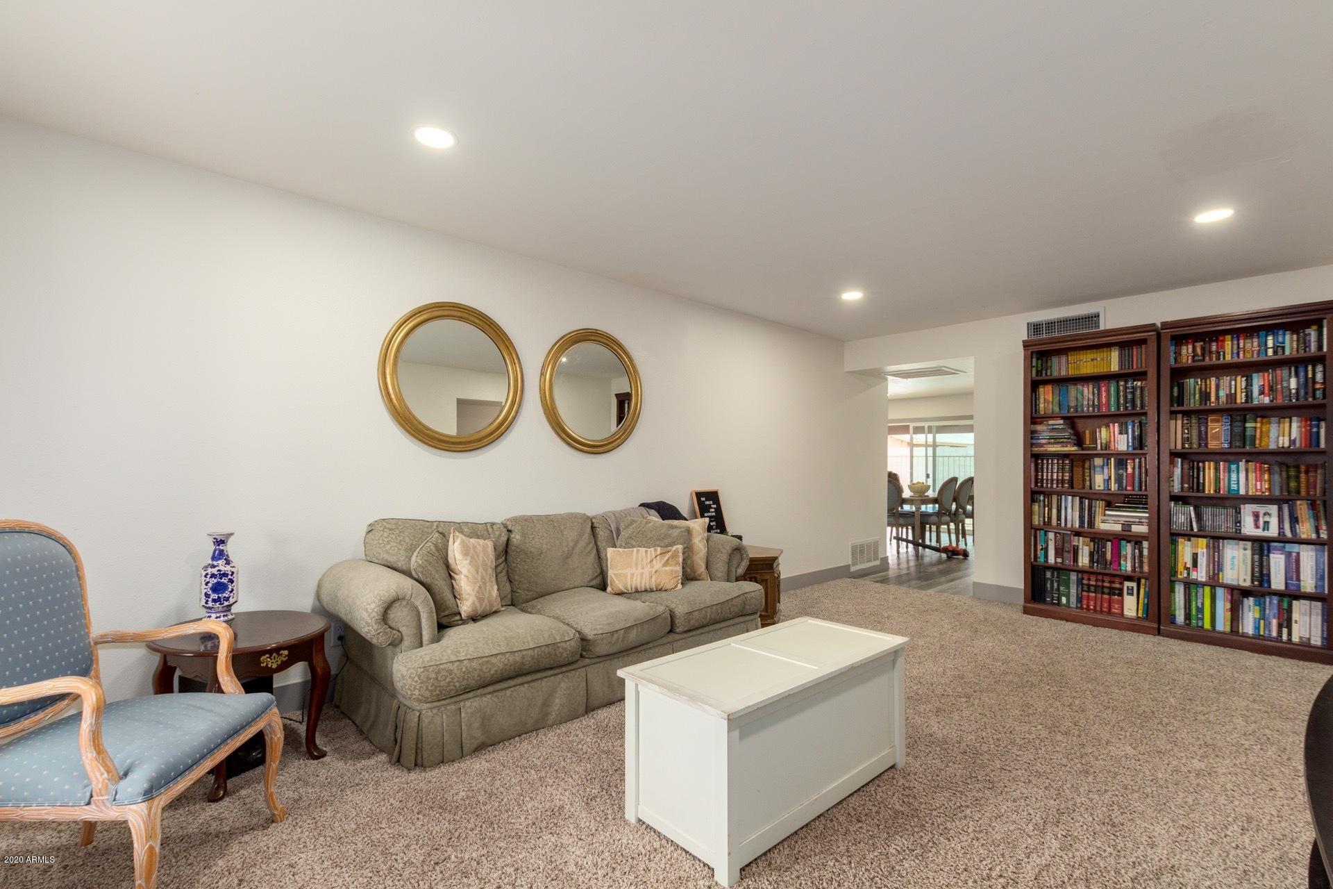 2439 East Riviera Drive Tempe, AZ 85282 - Photo 6 of 40 a living room with furniture and a book shelf