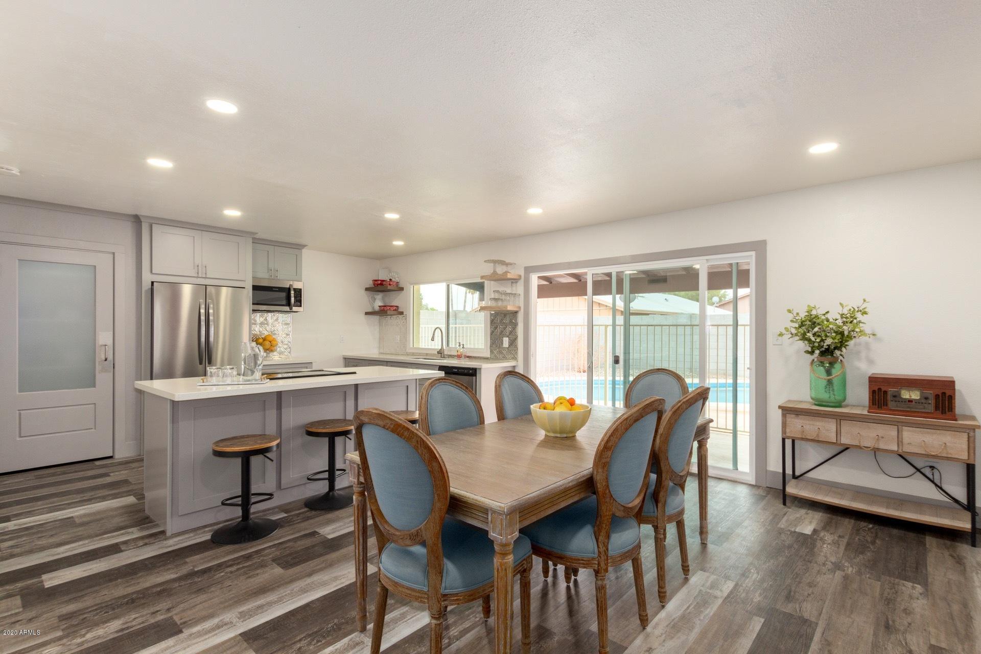 2439 East Riviera Drive Tempe, AZ 85282 - Photo 10 of 40 a view of a dining room with furniture window and wooden floor