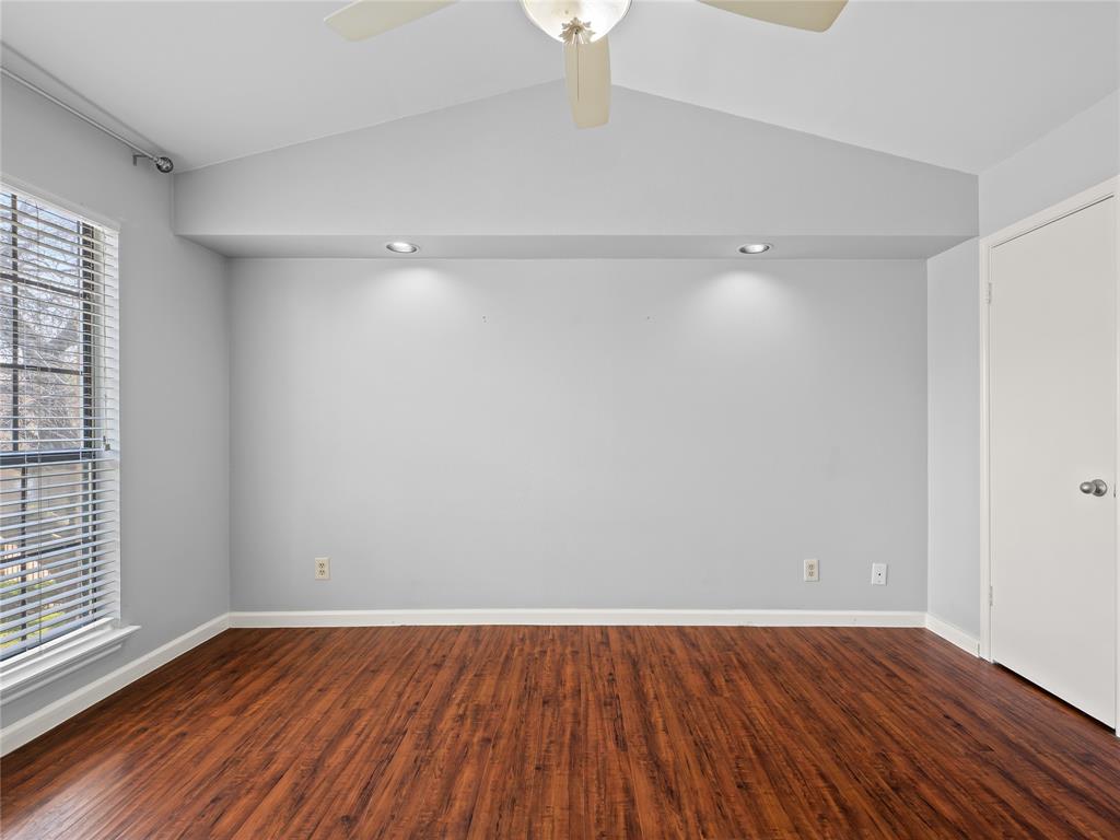 3101 Townbluff Drive, Unit 1024 Plano, TX 75075 - Photo 16 of 19 a view of an empty room with wooden floor and a window