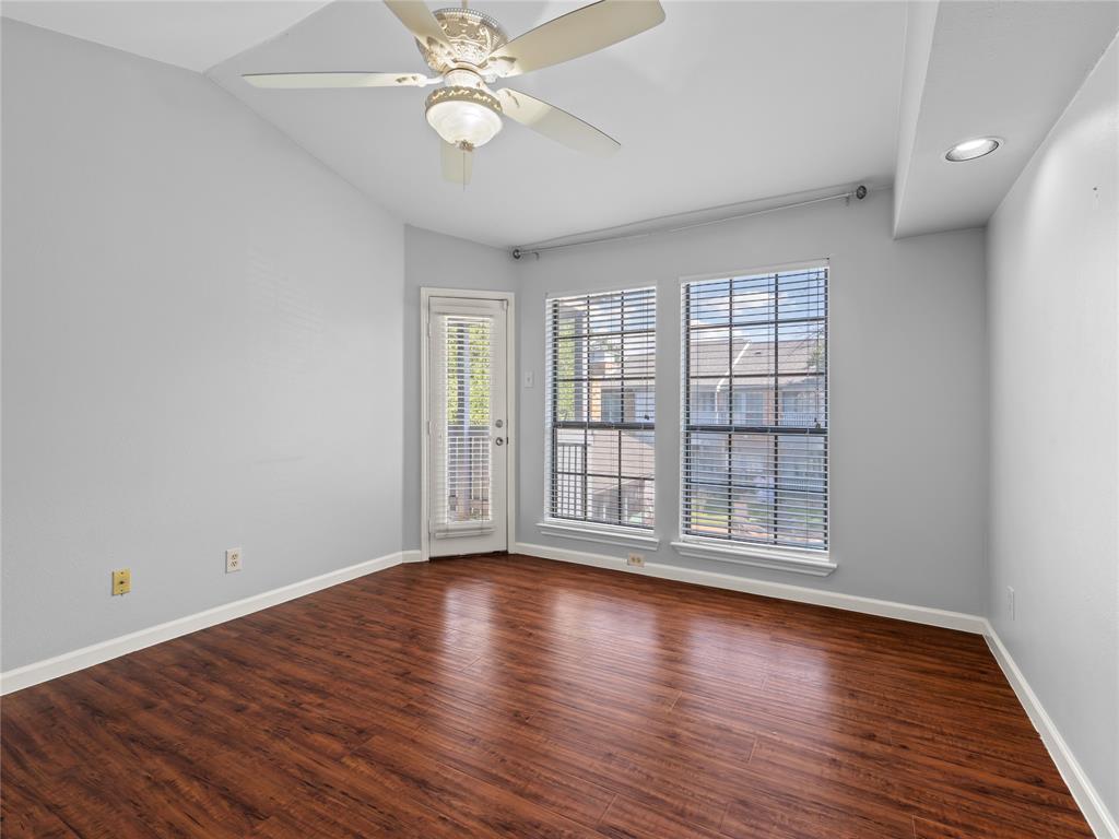 3101 Townbluff Drive, Unit 1024 Plano, TX 75075 - Photo 17 of 19 a view of an empty room with wooden floor and a window