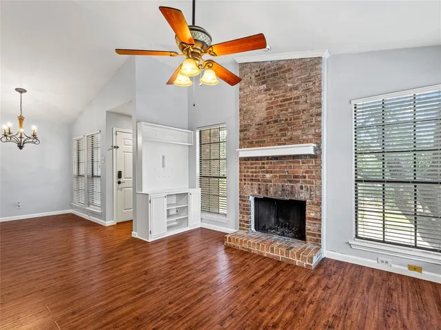 a view of a livingroom with a fireplace and wooden floor