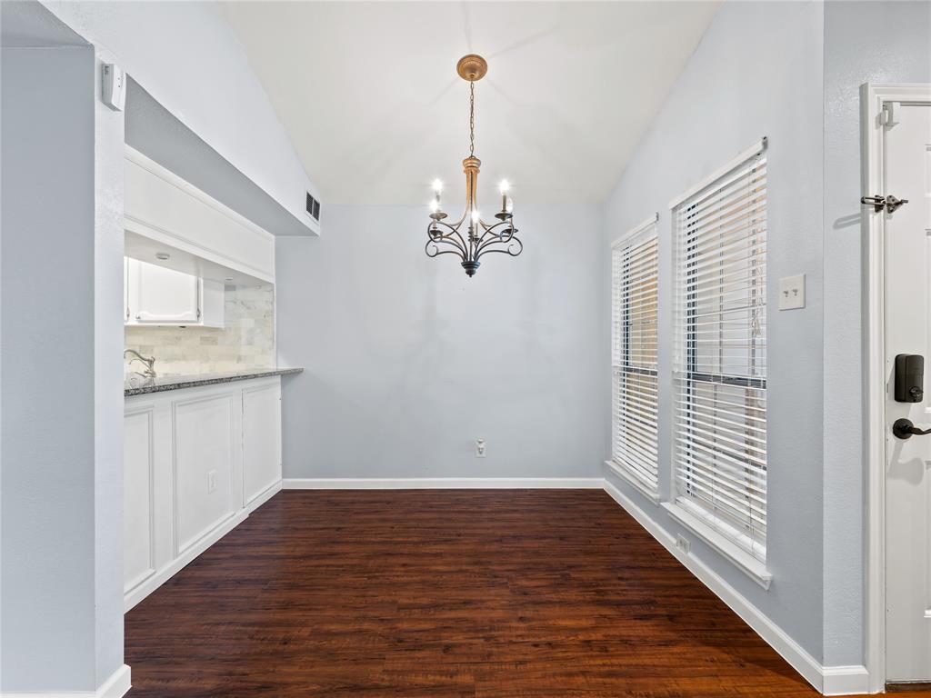 3101 Townbluff Drive, Unit 1024 Plano, TX 75075 - Photo 8 of 19 a view of a kitchen with wooden floor and a ceiling fan