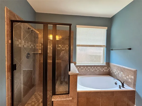 a bathroom with a bathtub and a shower