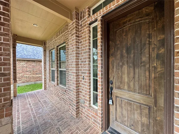 a view of a porch with a door and a wooden door