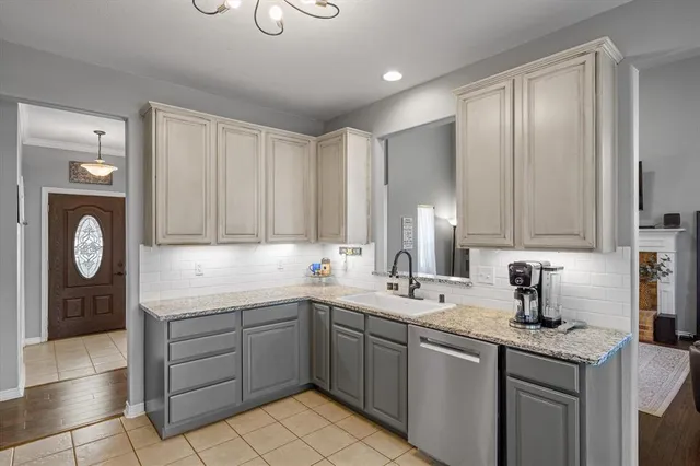 a kitchen with a sink cabinets and window