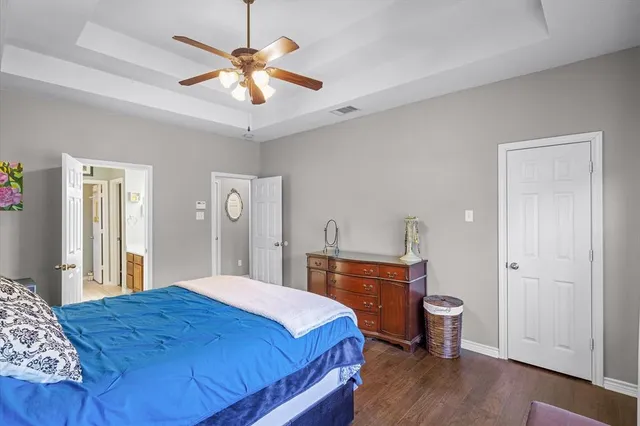 a bedroom with a large bed and a chandelier