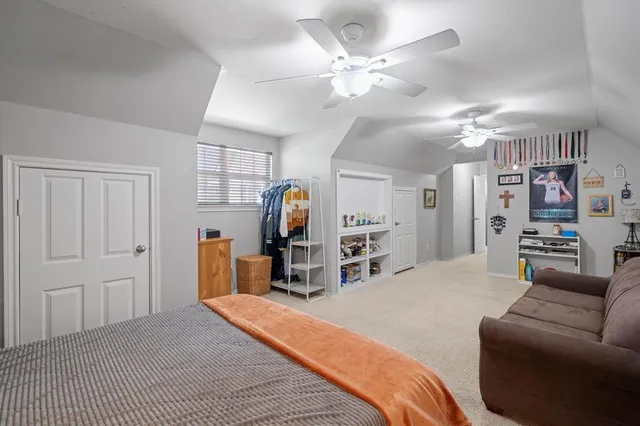 a bedroom with furniture and a large window
