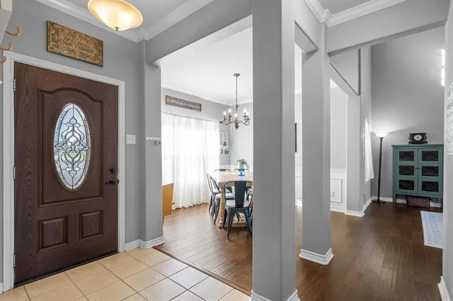 a view of a hallway with wooden floor and a bookshelf
