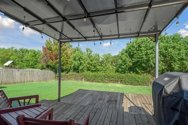 a view of yard with patio