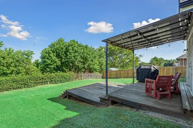 a view of a backyard with sitting area furniture and garden