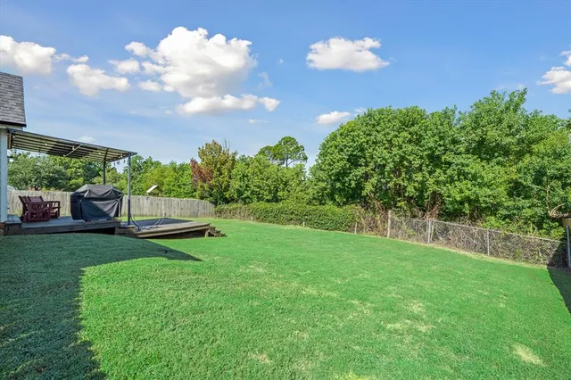a view of a backyard with sitting area