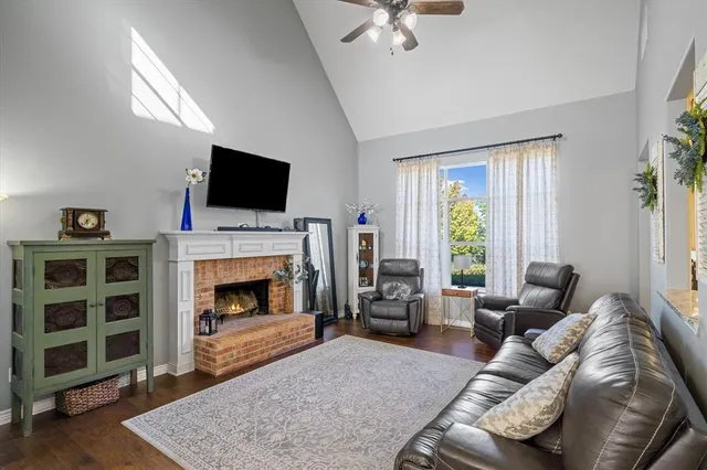 a living room with furniture a flat screen tv and a fireplace
