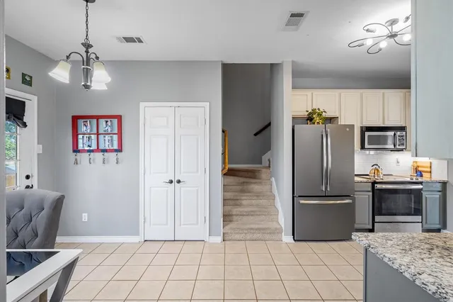 a kitchen with stainless steel appliances granite countertop a refrigerator and a sink