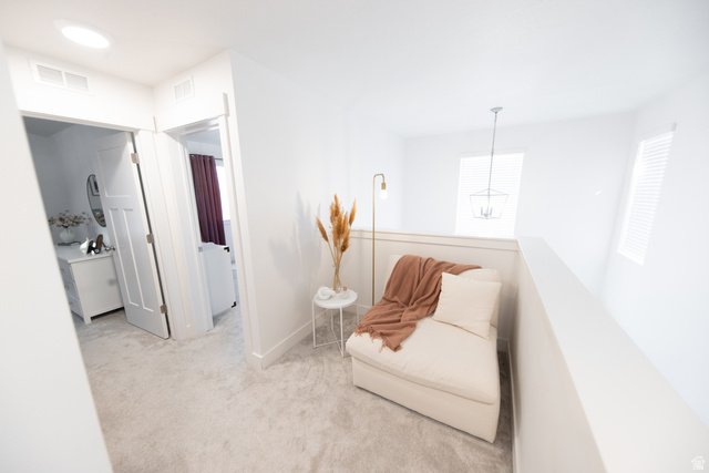 1404 East Rustic Wood Court Sandy, UT 84092 - Photo 13 of 33 Carpeted hallway featuring a skylight and a white railing overlooking a lower level