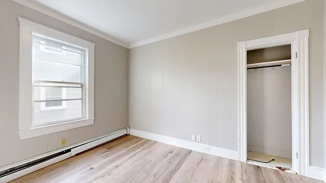 an empty room with windows and closet