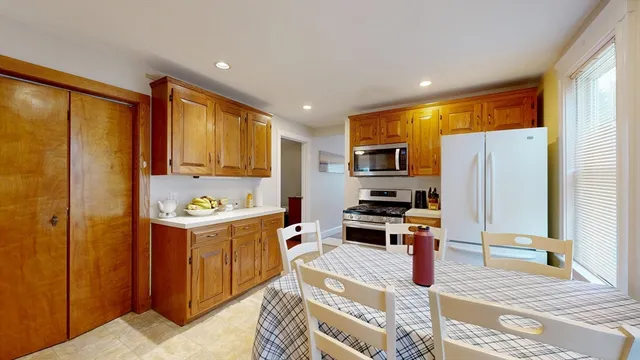 a kitchen with kitchen island a large counter top space appliances and cabinets