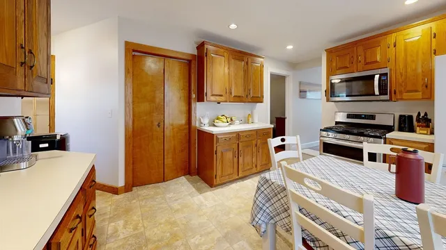 a kitchen with a wooden table and chairs