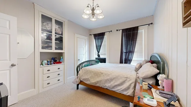 a bedroom with furniture and a window