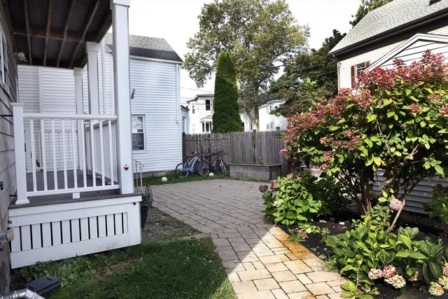 a view of a house with a yard and a garden