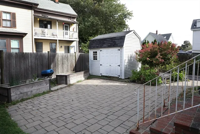 a view of a house with wooden fence