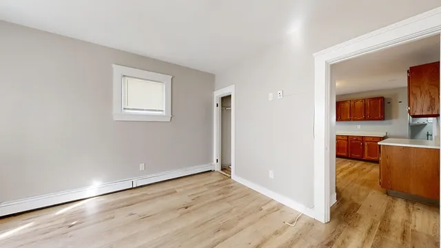 a view of a livingroom with wooden floor and furniture