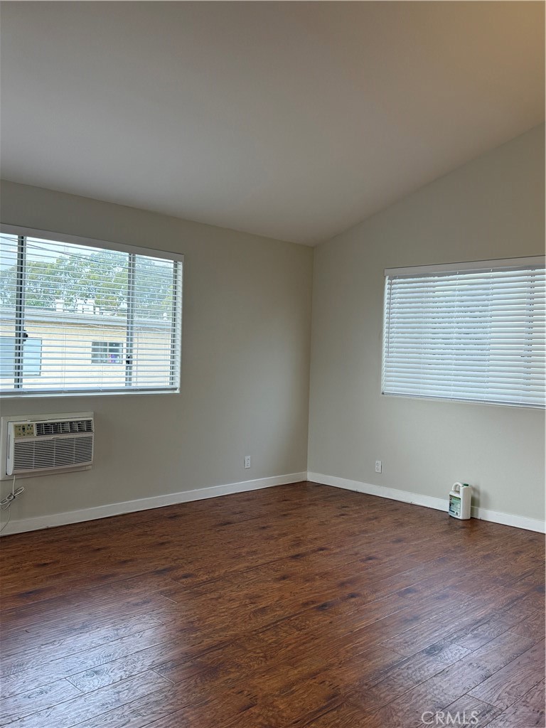 1131 252nd Street, Unit B Harbor City, CA 90710 - Photo 11 of 12 an empty room with wooden floor and windows