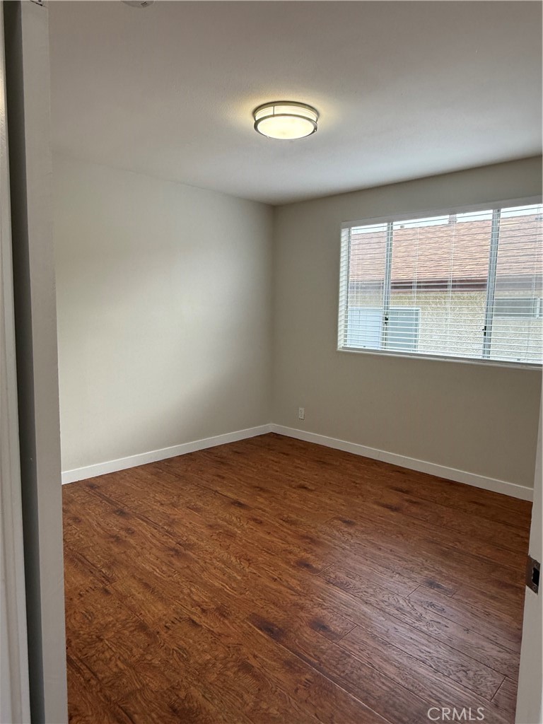 1131 252nd Street, Unit B Harbor City, CA 90710 - Photo 12 of 12 an empty room with wooden floor and windows