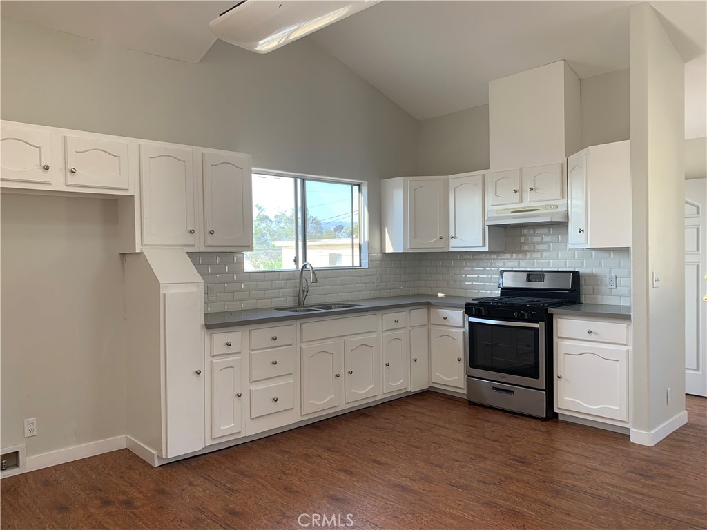 1131 252nd Street, Unit B Harbor City, CA 90710 - Photo 3 of 12 a kitchen with granite countertop white cabinets and white appliances