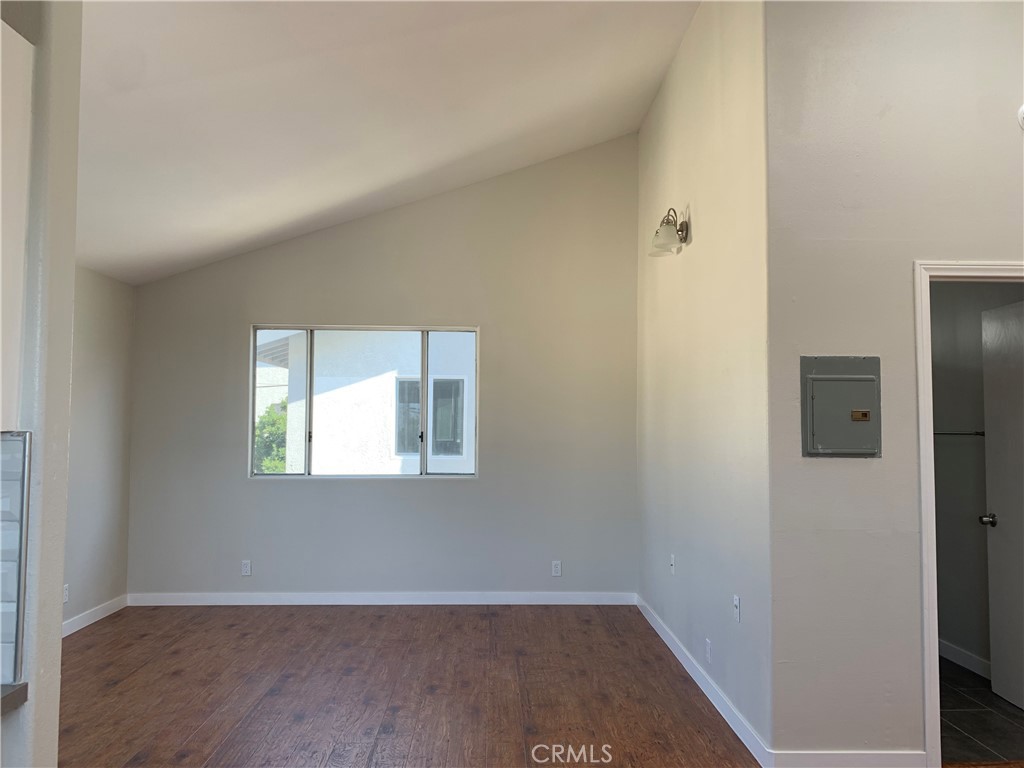 1131 252nd Street, Unit B Harbor City, CA 90710 - Photo 5 of 12 a view of an empty room with wooden floor and a window