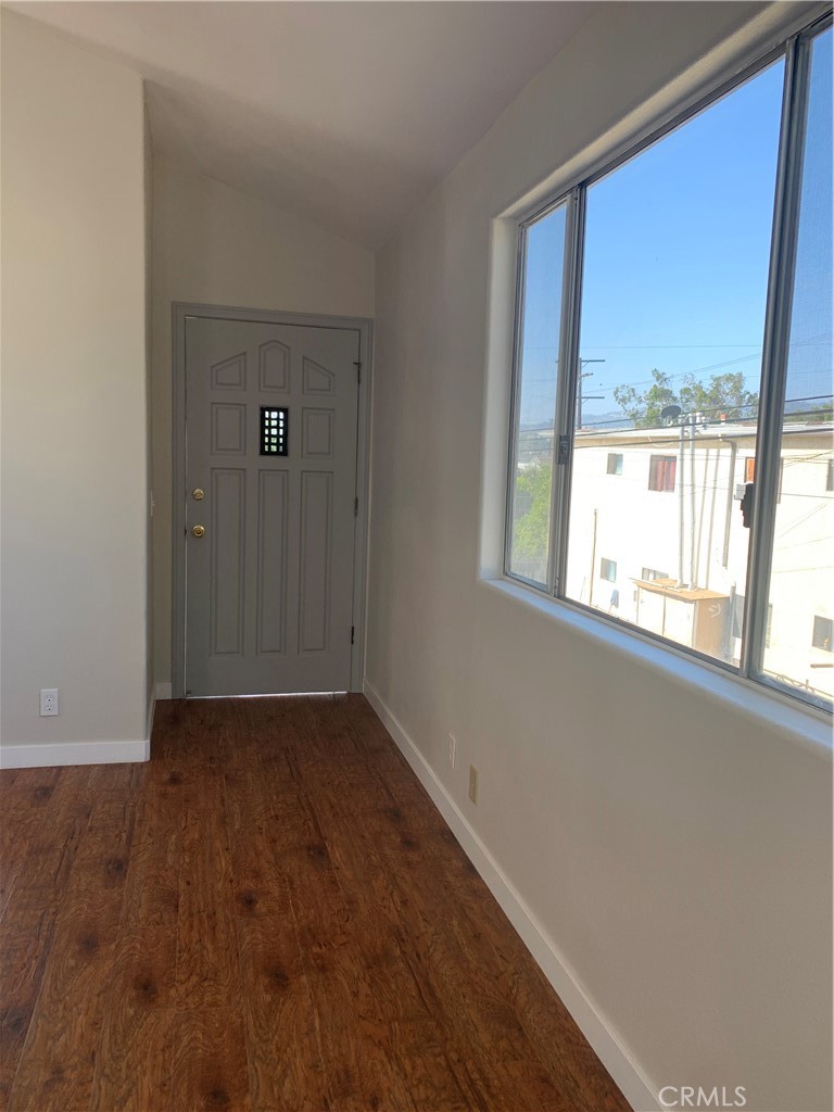 1131 252nd Street, Unit B Harbor City, CA 90710 - Photo 6 of 12 an empty room with wooden floor and windows