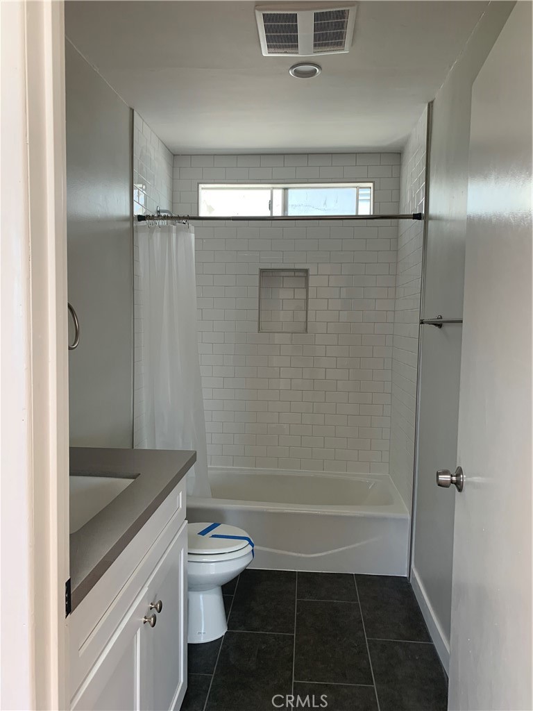 1131 252nd Street, Unit B Harbor City, CA 90710 - Photo 7 of 12 a bathroom with a granite countertop sink toilet and shower