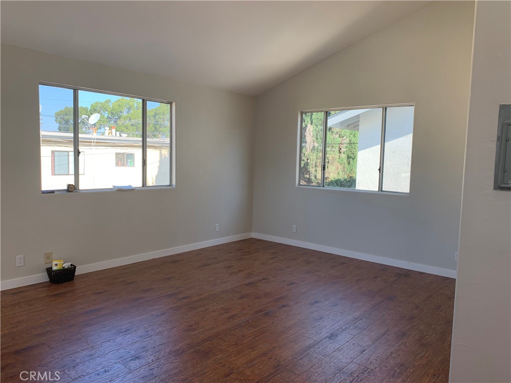 1131 252nd Street, Unit B Harbor City, CA 90710 - Photo 8 of 12 an empty room with wooden floor and windows