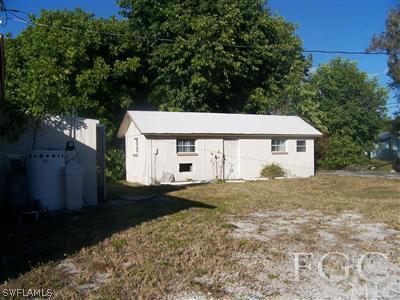 1112 Patterson Road Cape Coral, FL 33909 - Photo 2 of 7 a view of a house with a yard and large tree