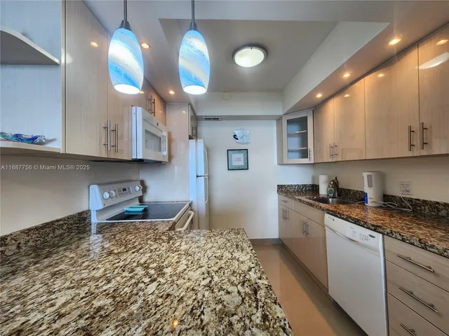 a kitchen with stainless steel appliances granite countertop a sink and cabinets