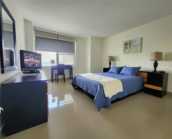 a spacious bedroom with a bed and furniture