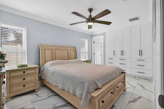 a bedroom with a large bed and a chandelier