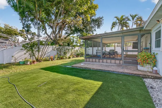 a view of a house with backyard and sitting area