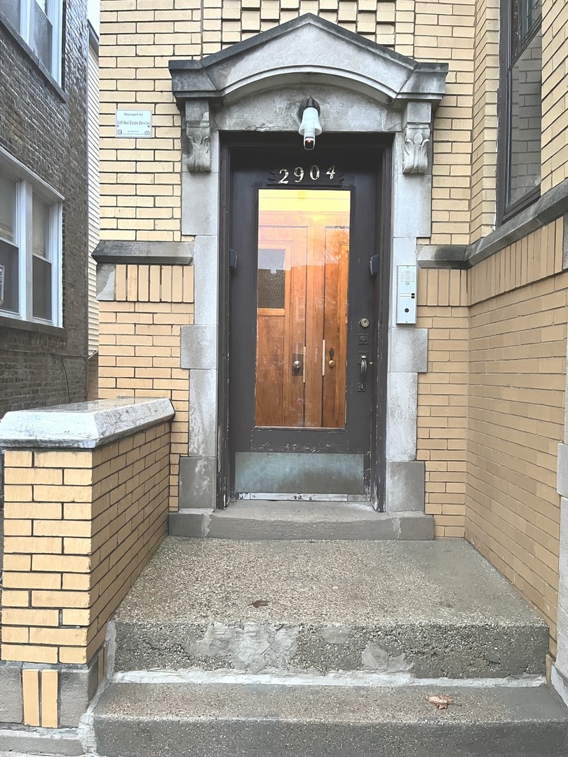 2904 North Linder Avenue, Unit 2 Chicago, IL 60641 - Photo 2 of 2 a front view of a house with a outdoor space