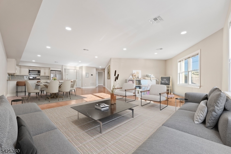 658 Market Street Paterson, NJ 07513 - Photo 11 of 19 a living room with lots of furniture and view of kitchen