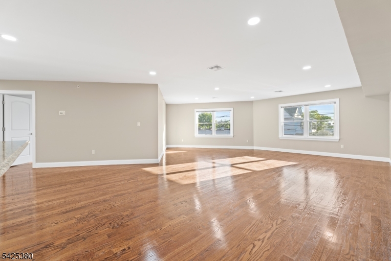 658 Market Street Paterson, NJ 07513 - Photo 14 of 19 an empty room with wooden floor and windows