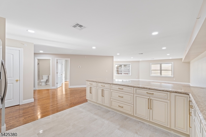658 Market Street Paterson, NJ 07513 - Photo 16 of 19 a spacious bathroom with a granite countertop sink and a mirror