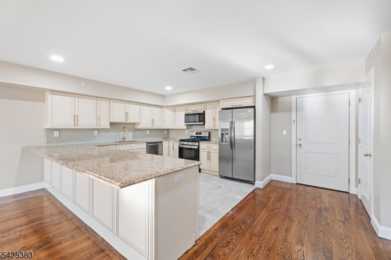 658 Market Street Paterson, NJ 07513 - Photo 19 of 19 a kitchen with stainless steel appliances granite countertop a refrigerator and a sink