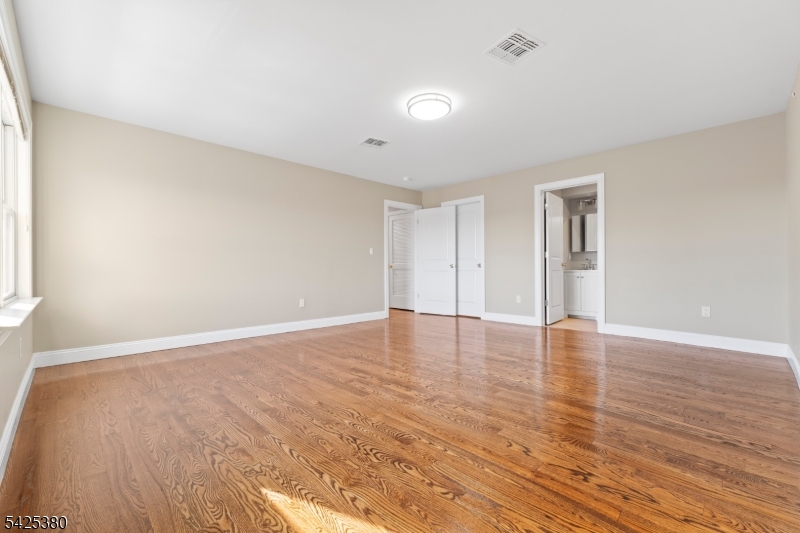 658 Market Street Paterson, NJ 07513 - Photo 3 of 19 a view of an empty room with wooden floor