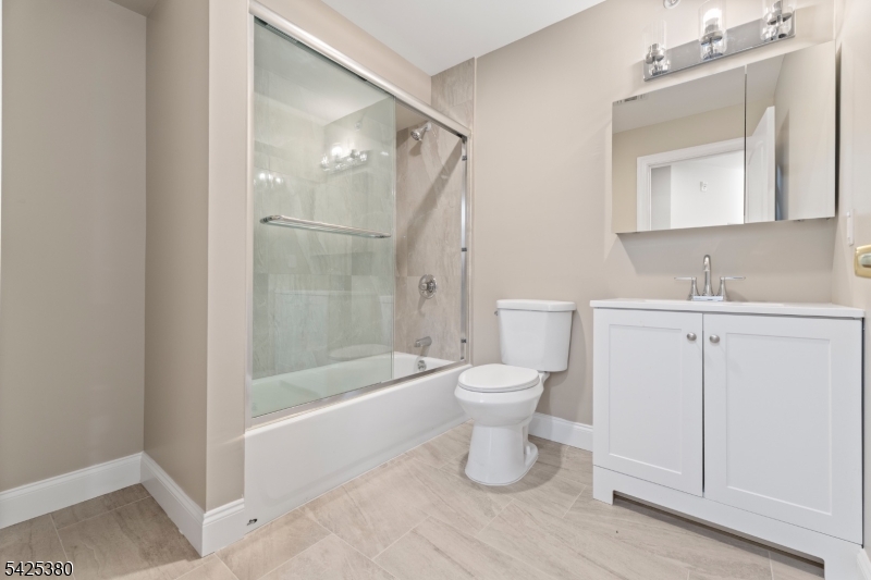 658 Market Street Paterson, NJ 07513 - Photo 6 of 19 a bathroom with a toilet sink and a mirror